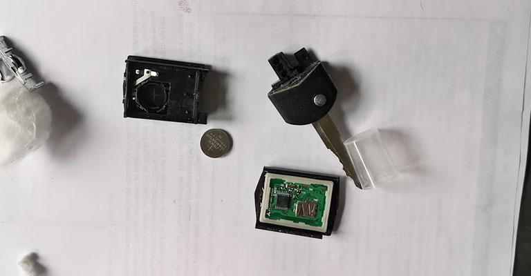 A faulty key fob and its battery